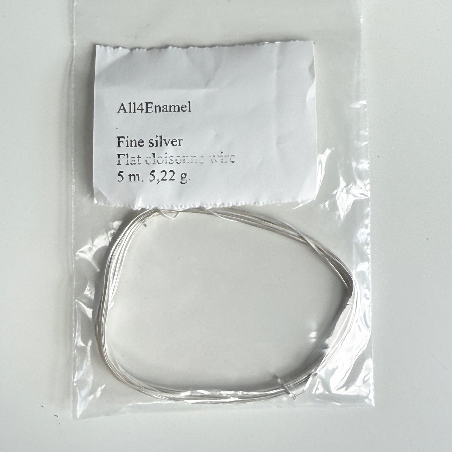 Packaged fine silver wire with a label on a white background