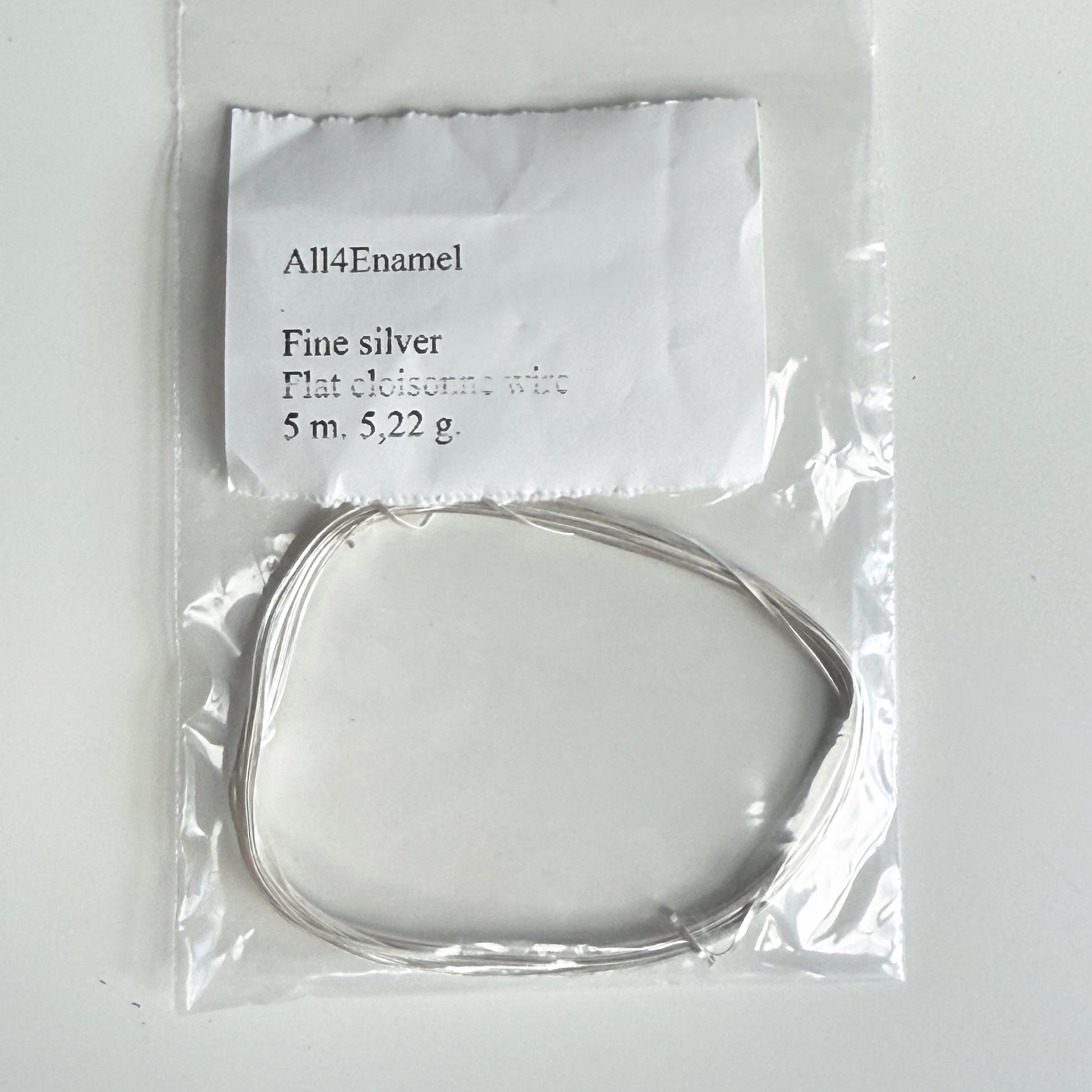 Packaged fine silver wire with a label on a white background